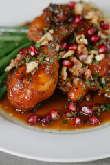 A leg of chicken slow cooked with pomegranate