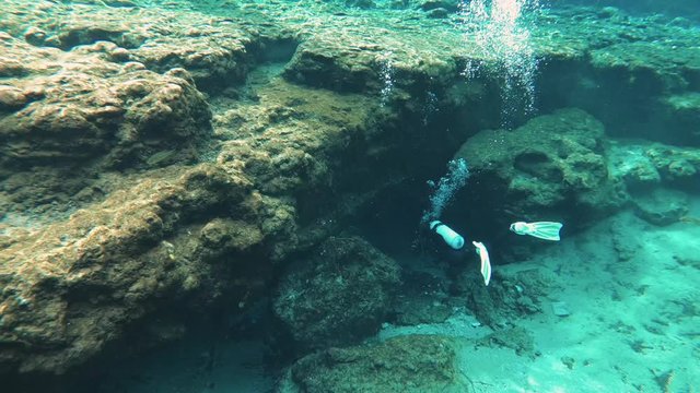 Divers entering cave