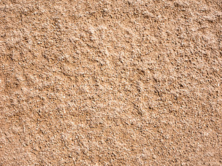 Concrete wall with pieces of small stone.
