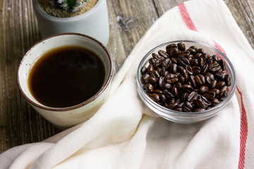 A top down view of Japanese style coffee with roasted coffee beans, in a restaurant or kitchen setting.