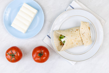 Tortilla served with fried sausage and green peas