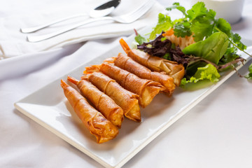 A view of a Vietnamese appetizer known as rocket shrimp, in a restaurant or kitchen setting.