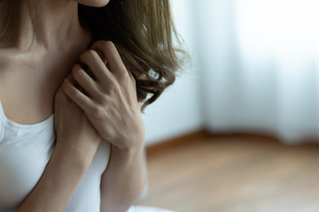 Fototapeta premium Asian Woman Has Chest Pain Sitting on bed in bedroom after wake up in morning.Health care concept.