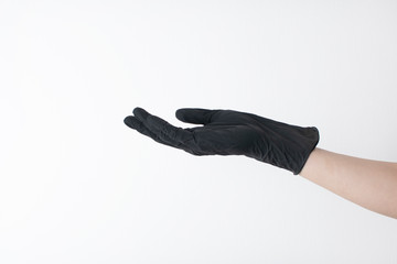 hand black gloves of doctor or hair stylist on white background. gloves are worn on the arm