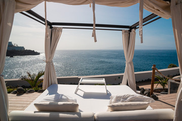Sunbathing bed in a luxury pool hotel with stunning ocean views