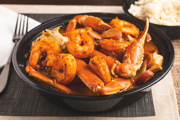 A view of a bowl of seafood gumbo, in a restaurant or kitchen setting.