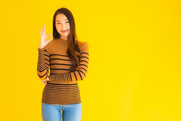 Portrait beautiful young asian adult woman smile with many action on yellow background