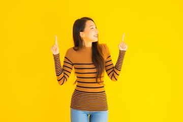 Portrait beautiful young asian adult woman smile with many action on yellow background