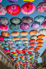 Fototapeta na wymiar Colorful umbrellas on blue sky