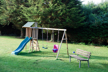 Looe (England), UK - August 12, 2015: Swing and bench in Looe park, Cornwall, United Kingdom...