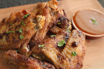 Delicious chicken wings, baked or fried chicken wings served with hot spicy  barbeque sauce