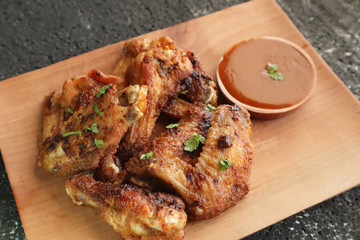Delicious chicken wings, baked or fried chicken wings served with hot spicy  barbeque sauce