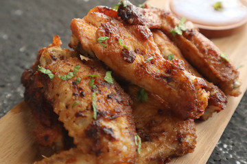 Delicious chicken wings, baked or fried chicken wings served with hot spicy  barbeque sauce