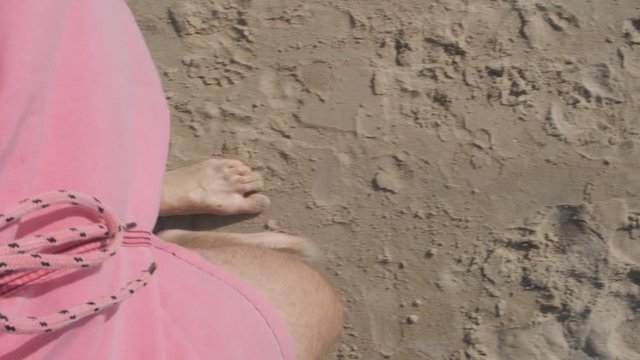 slow point of view motion video of the legs and foots of a young men walking on the sand and water of the beach of Solanas, Maldonado, Punta del Este