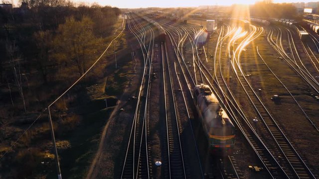 train at the fork of the tracks at sunset aerial view.
