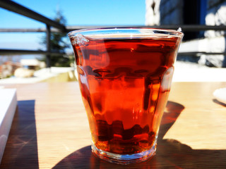 a glass of red tea in the sun 