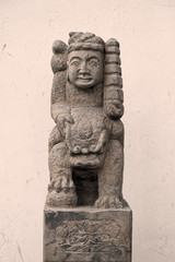 Stone pillar sculpture of ancient Chinese figures riding Lions