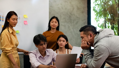 Handsome man at the right side,Boss talking to blurred Young business people working ,with colleagues team meeting,