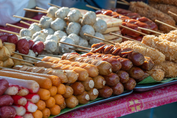 Sausages and meat balls on sticks on street food market in Koh Phangan island, Thailand