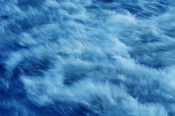 Sea waves at long exposure close up. Toned photo. Spectacular abstract background.