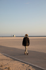 man walking on the beach with surgical mask