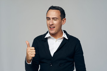 young businessman showing thumbs up