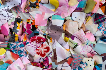 Background colorful pieces of fabric to shreds.