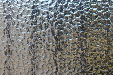 Textured vintage window pane of privacy glass in a bathroom.