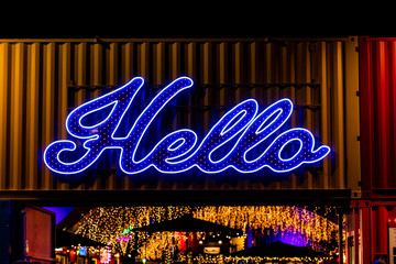 A Bright Neon Hello Sign Above a Doorway
