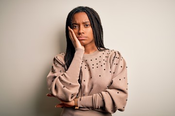 Young african american fashion woman standing casual over brown isolated background thinking looking tired and bored with depression problems with crossed arms.