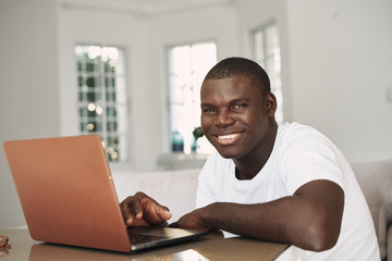 man of african appearance with a laptop