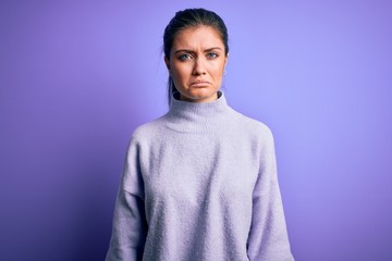 Obraz premium Young beautiful woman with blue eyes wearing casual turtleneck sweater over pink background depressed and worry for distress, crying angry and afraid. Sad expression.