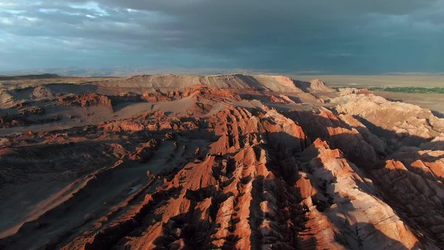 Aerial view of dramatic landscape caused by erosion at the Moon Valley (Spanish: Valle de la Luna ) at sunset in the Atacama Desert, Chile, South America.