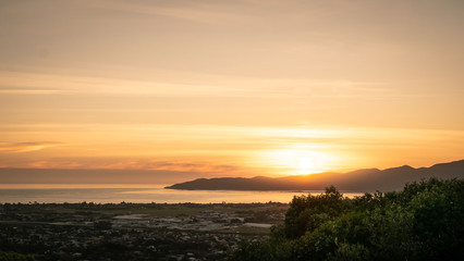Sunset shot with colourful sky with mountain backdrop (Kapiti Island) shot on outlook above Paraparaumu on Kapiti coast, Wellington, North Island