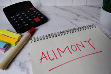 Alimony write on a book and keyword isolated on Office Desk.