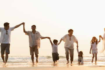 Naklejka premium Lifestyle. Asian families on the beach. Travel, Vacations, Post Crisis Vacations