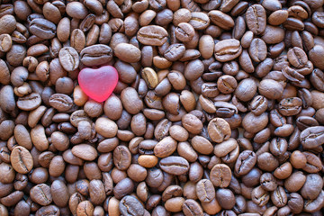 Coffee beans with a red heart. Close-up. Concept of love for natural coffee.