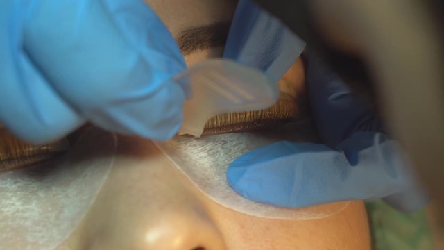 Professional change in the shape of female eyelashes in a beauty salon