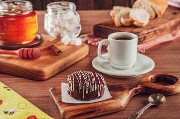 Honey cookie chocolate covered on the wooden table with coffee - pão de mel