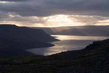 Fjord illuminated by sunset in Westfjords Iceland
