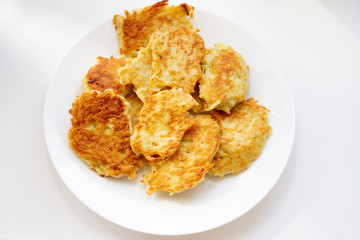 fried potato pancakes on a white plate