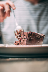 eating glazed chocolate cake