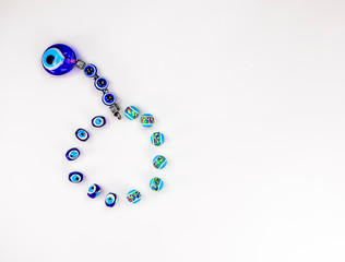 Pretty Turkish evil eye pendants isolated against a white background