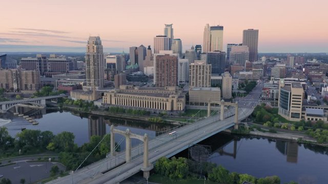 Aerial: Minneapolis Hennepin Avenue Bridge & city skyline at sunrise. Minnesota. 