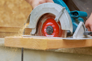 Cutting wood using an electrical chain saw professional tools
