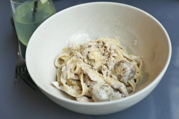 Close up of fresh pasta in a bowl on table.
