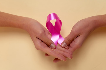 female hands holding a pink manicure