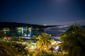 a moonlit beach scene on a tropical island