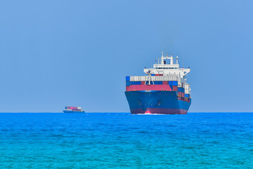 Naklejka premium Container ship sailing in the sea arrives at port Logistic import export background of container Cargo ship seaport on sunset, or twilight Fright Transportation.