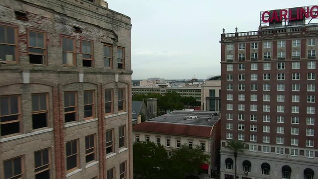 Aerial flying back past windows of abandoned building in downtown Jacksonville